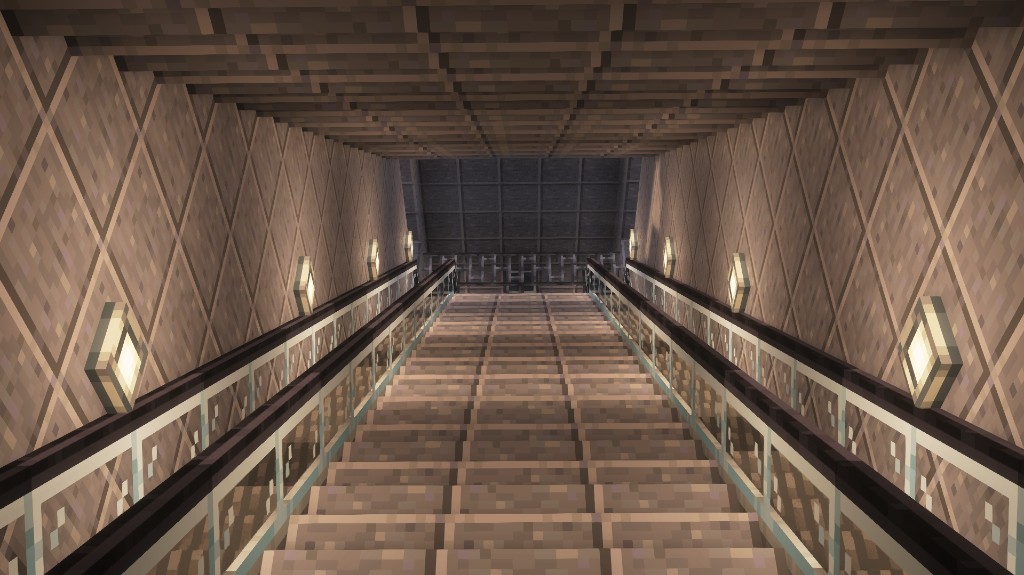 Station stairwell leading down toward platforms with modern lighting.