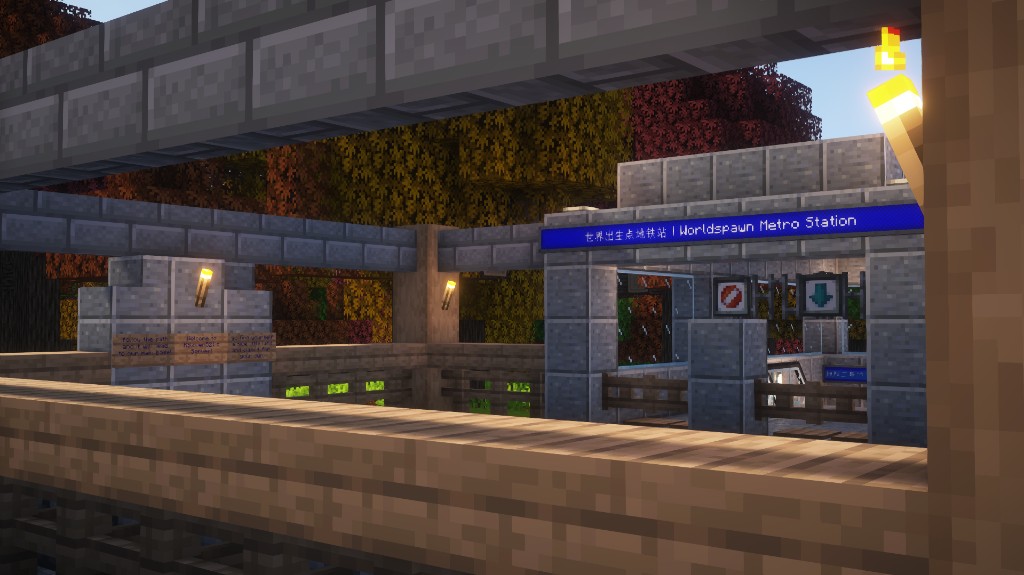 Surface station entrance with signage and autumn trees.